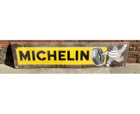 A vintage enamel advertising sign for Michelin, of rectangular form, with iconic image of Mr. Bibendum rolling a tyre, 195cm 