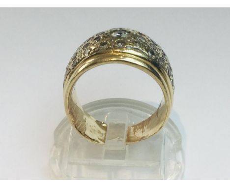 A 14ct yellow gold diamond ring set with one round brilliant cut diamond to the centre and 42 x smaller diamonds surrounding,