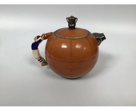 A rare 1930's commemorative F.A. cup pottery teapot by Sadlers of Burslem, modelled as a football with footballer handle, the