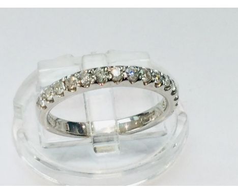 An 18ct white gold wedding ring set with 15 x round brilliant cut diamonds in a pave style setting, estimated weight 0.50cts,