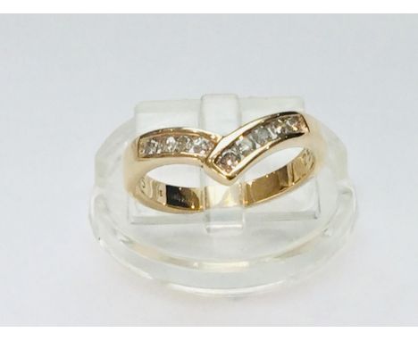 An 18ct yellow gold diamond 'wishbone' ring, set with 9 x round brilliant cut diamonds in a channel setting, total weight of 