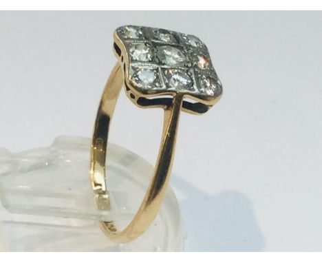 An 18ct gold and platinum diamond ring,  set with 9 x round brilliant cut diamonds in a Deco style, estimated total weight of