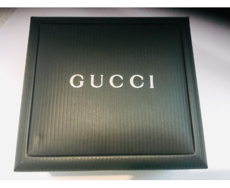 A Gucci 1900L gold coloured stainless steel watch, with square white face and Gucci stamped fastening, in original box. Toget