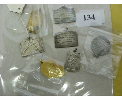 Rodue G Maspoli, a collection of 7 medals/badges as inscribed and given to Mr Maspoli who was an official member of the Urugu