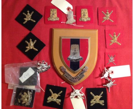 Sultan of Oman Land Forces badges. Comprising Force Ordnance Services wooden shield with 16 metal and cloth & bullion badges.