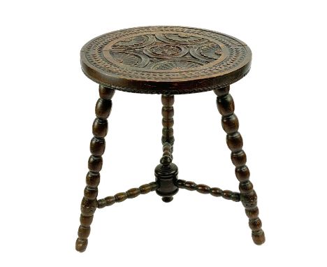 A Victorian carved circular tripod table. With bobbin turned legs and stretchers, height 55cm diameter 45.5cm.