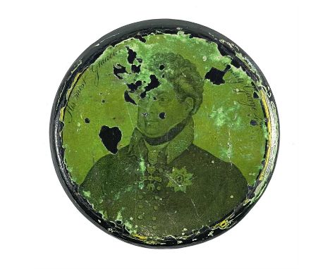 A George IV lacquered papier mache circular portrait snuff box. The image printed on a green ground, diameter 8.5cm.