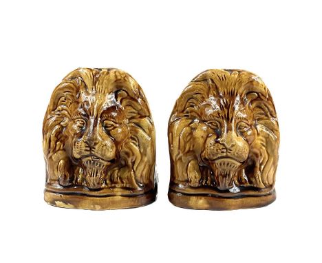 A pair of 19th century treacle glaze lion sash window supports. Height 13cm.