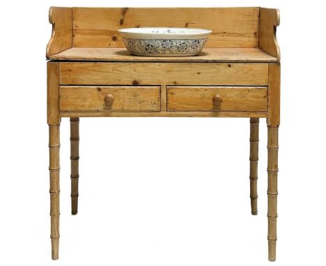 A 19th century pine washstand. With two drawers on simulated bamboo supports and a ceramic wash basin, height 93cm width 84cm