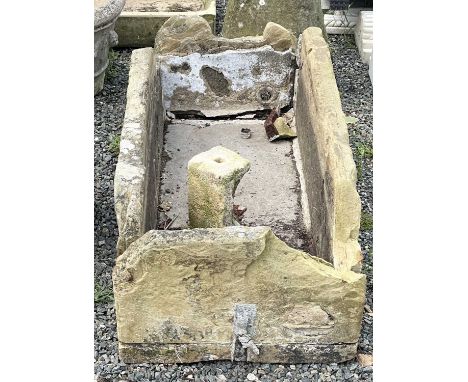 A large sandstone rectangular trough. Height 38cm width 116cm depth 57cm together with a stone carved architectural detail.