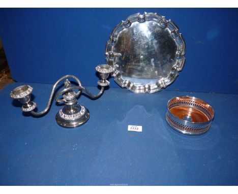 An Arthur Price plated tray (10" diameter), a pierced bottle coaster and a two branch candelabra. 