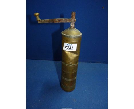 An antique brass coffee/spice grinder, (dent) a/f.  10" tall.