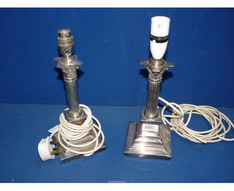 A pair of silver plated table Lamps with Corinthian columns standing on square bases, to include light fitting, 13" tall. 