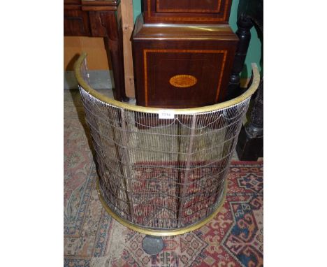 A brass topped and metal half moon Fireguard, 24" tall x 25" wide.