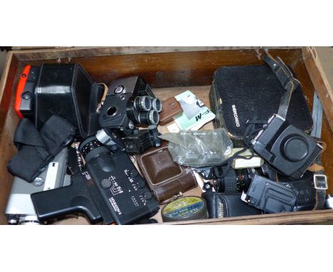 A selection of cameras including Super 8 in a wooden trunk