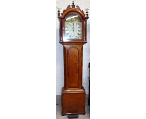 A late 18th century oak and mahogany longcase clock with fretted pediment and brass finials, the trunk with arched crossbande