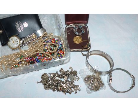 A millefiori necklace and bracelet; a silver bangle; a charm bracelet and charms; costume jewellery; etc.