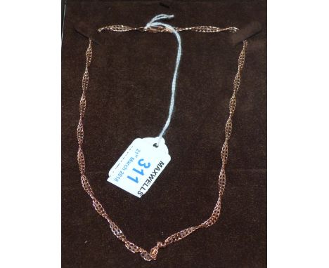 A rose gold twisted meshwork necklace stamped '9K', 5.1 gm; a modern silver coloured bangle; a brushed metal bangle; a gilt b