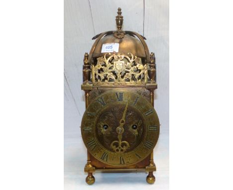 A Victorian brass lantern clock with twin fusee movement, anchor escapement striking to the bell, engraved faceplate, and dep