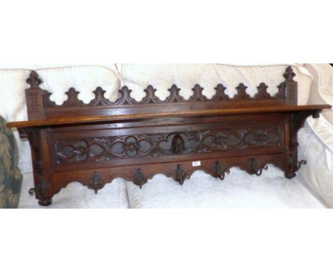 A Victorian style carved oak coat rack with shelf over