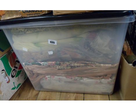 A crate containing a quantity of assorted textiles including curtains, etc.