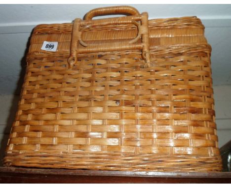 An old wicker picnic hamper with fitted interior