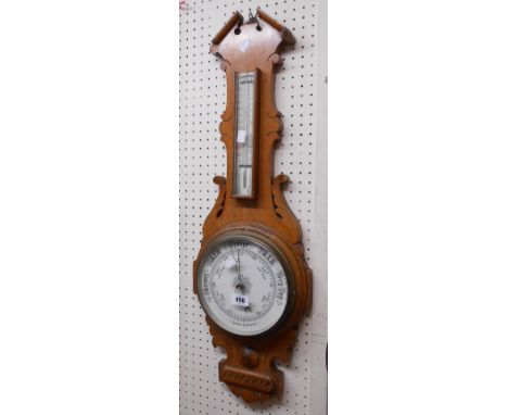 A late Victorian ornate golden oak cased banjo barometer/thermometer with printed ceramic dial and aneroid works - dial crack