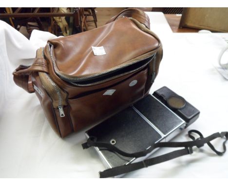 A Polaroid SX70 Sonar auto focus land camera and case