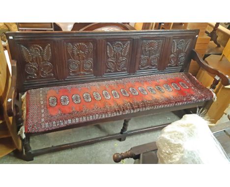 A 1.9m antique style oak bench seat by Brights of Nettlebed with floral decorated five panel back, solid seat and flanking ar