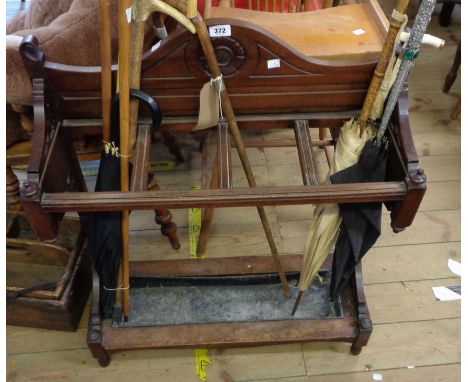 A 74cm Edwardian walnut freestanding hall stick stand with carved and pierced decoration, set on standard ends with original 