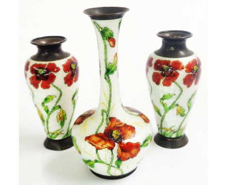 A trio of enamelled small white metal vases comprising an 11.5cm bottle vase and pair of 8.5cm slender bulbous vases, all wit