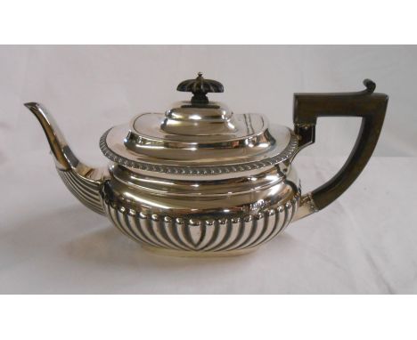 A silver teapot of semi-reeded oval design - London 1906