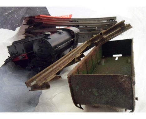A bag containing a train set comprising a quantity of track, clockwork engine and associated carriage