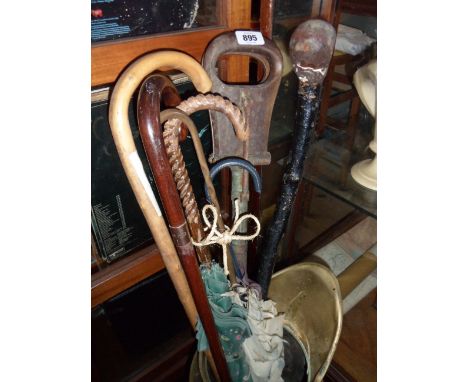 A selection of walking sticks, etc. including antique shooting stick, 9ct gold mounted walking cane, etc.