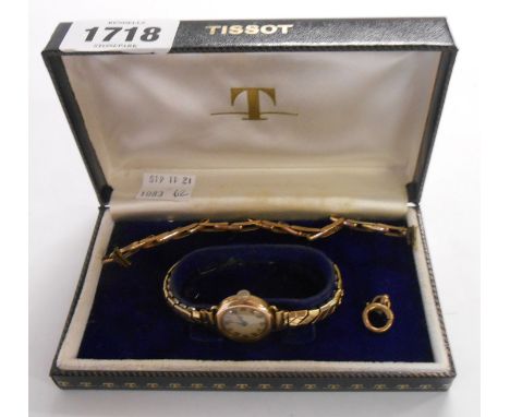 A Tissot box containing a vintage 9ct. gold cased lady's wristwatch on plated expanding strap - sold with a yellow metal expa
