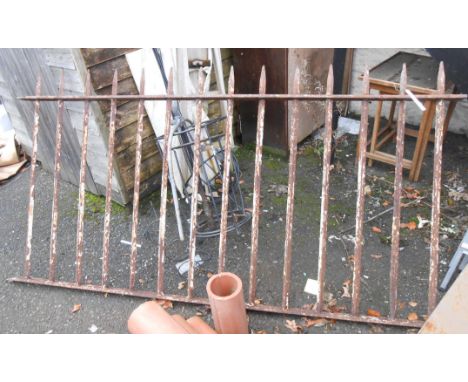 A vintage wrought iron railing section with remains of original paint