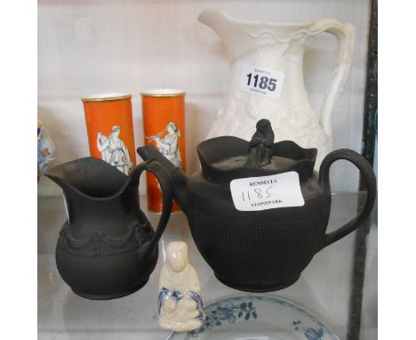 An early 19th Century black basalt teapot and a similar cream jug - sold with a Victorian relief moulded parian jug and a pai