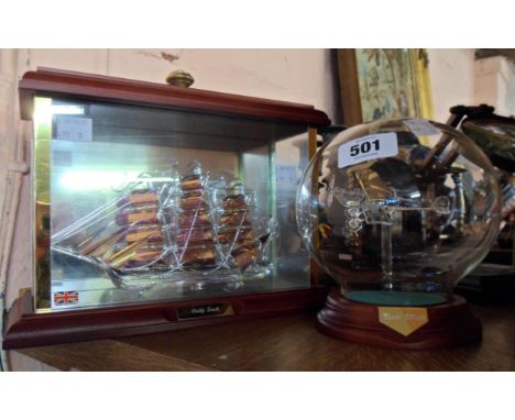 A display case containing a lamp work glass model of The Cutty Sark - sold with a similar of a Tiger Moth aircraft