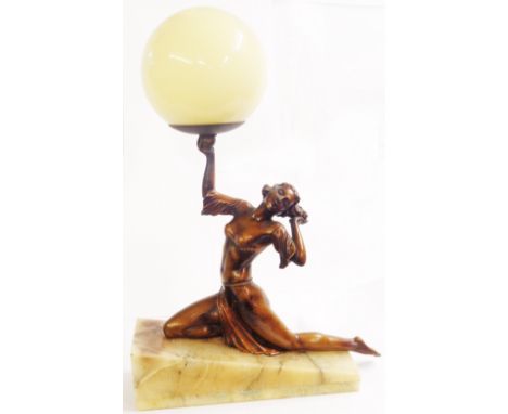 An Art Deco spelter lamp depicting a lady holding light aloft on a marble base with glass shade