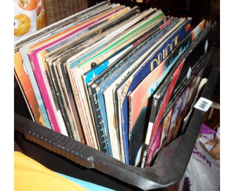 A crate containing a quantity of LP records including Now 2 &amp; 3, Bad Company, Slade, Ian Jury and the Blockheads, Stevie 