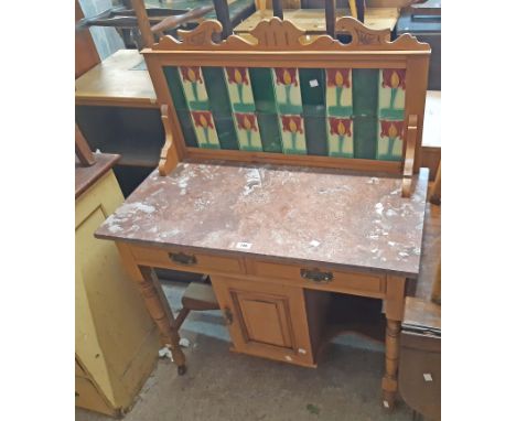 A 92cm Edwardian satin walnut marble topped washstand with decorative tile set splashback, two frieze drawers and central cup