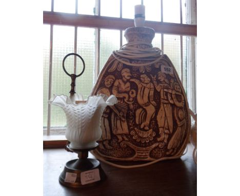 A large vintage plaster table lamp depicting figures making merry - sold with a reproduction candle lamp with glass shade