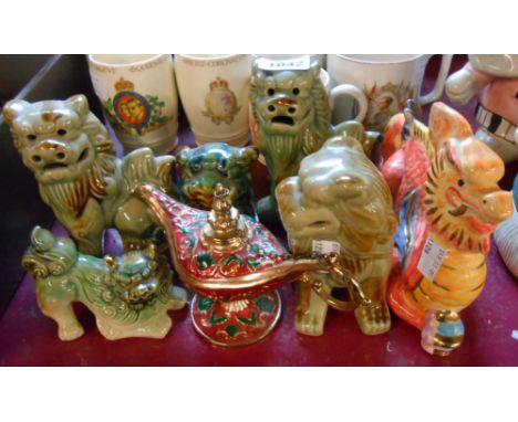 Four 20th Century Chinese pottery dog fo models - sold with a dragon figurine and a metal novelty lamp