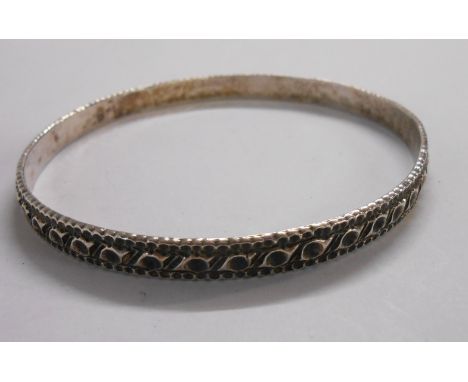 A Charles Horner cast silver bangle with repeat loop design - Chester 1893