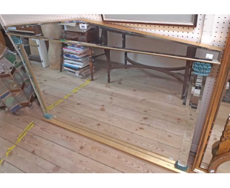 A decorative gilt framed bevelled overmantel mirror of stylised architectural design with multiple bevelled plates and flanki