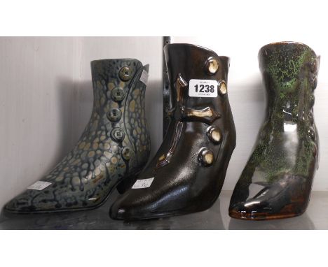 Three ceramic boots with decorative coloured glazes