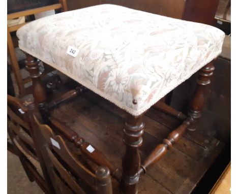 A mahogany framed dressing stool with modern tapestry upholstered top, set on an open stretcher base with turned supports