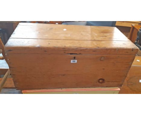 An 81cm Victorian stained pine lift-top trunk with flanking heavy iron drop handles - split to top and other wear