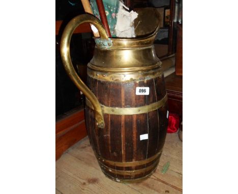 A large coopered barrel form jug with brass spout and handle for use as a stick stand