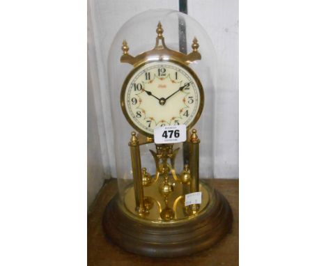 A vintage Kundo anniversary clock with ball pendulum, under glass dome